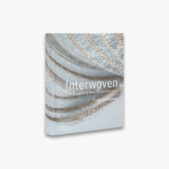 Book titled 'Interwoven' with a close-up of woven material on the cover.