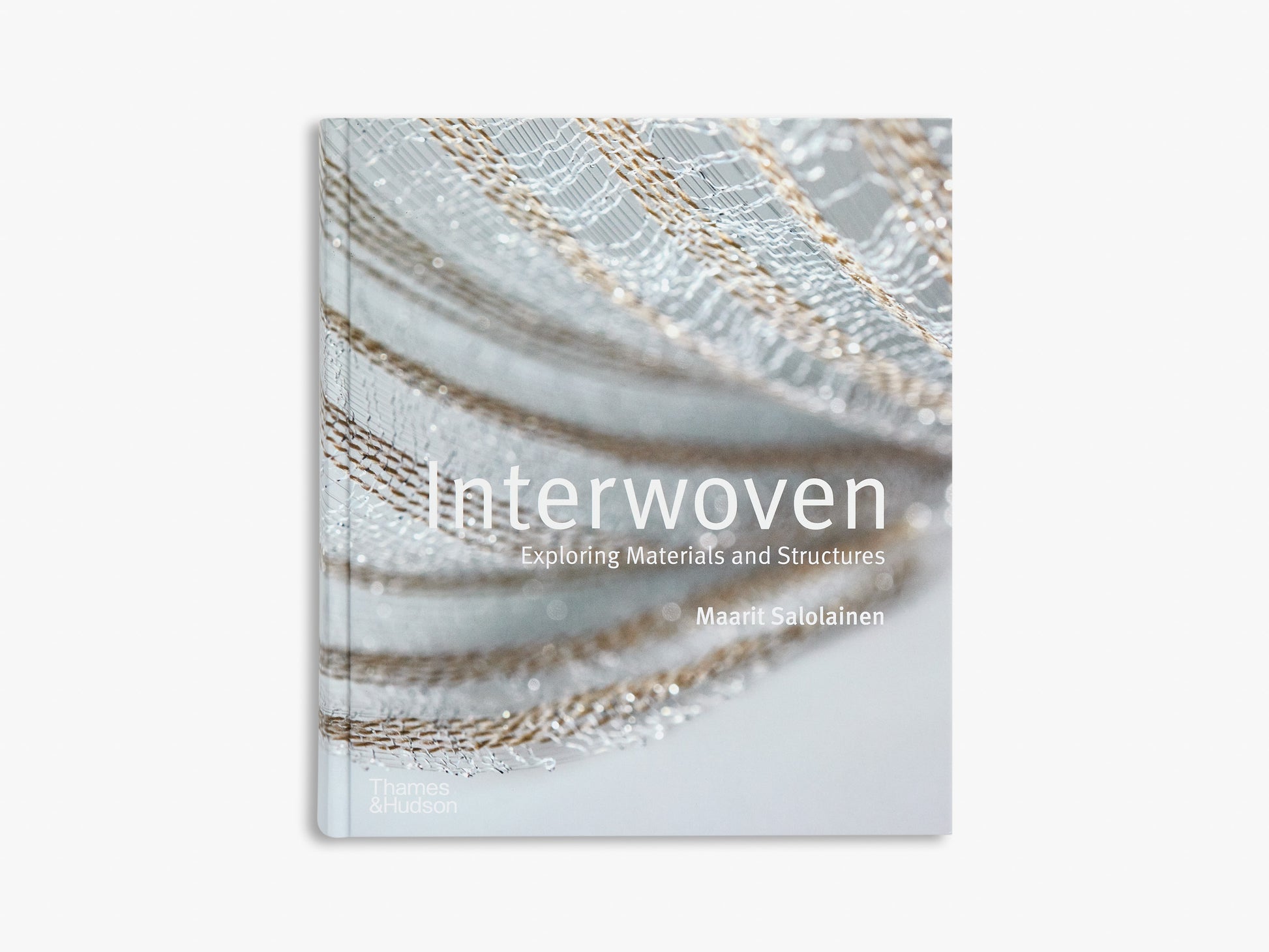 Book titled 'Interwoven' with a close-up of woven materials on the cover.