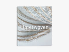 Book titled 'Interwoven' with a close-up of woven materials on the cover.