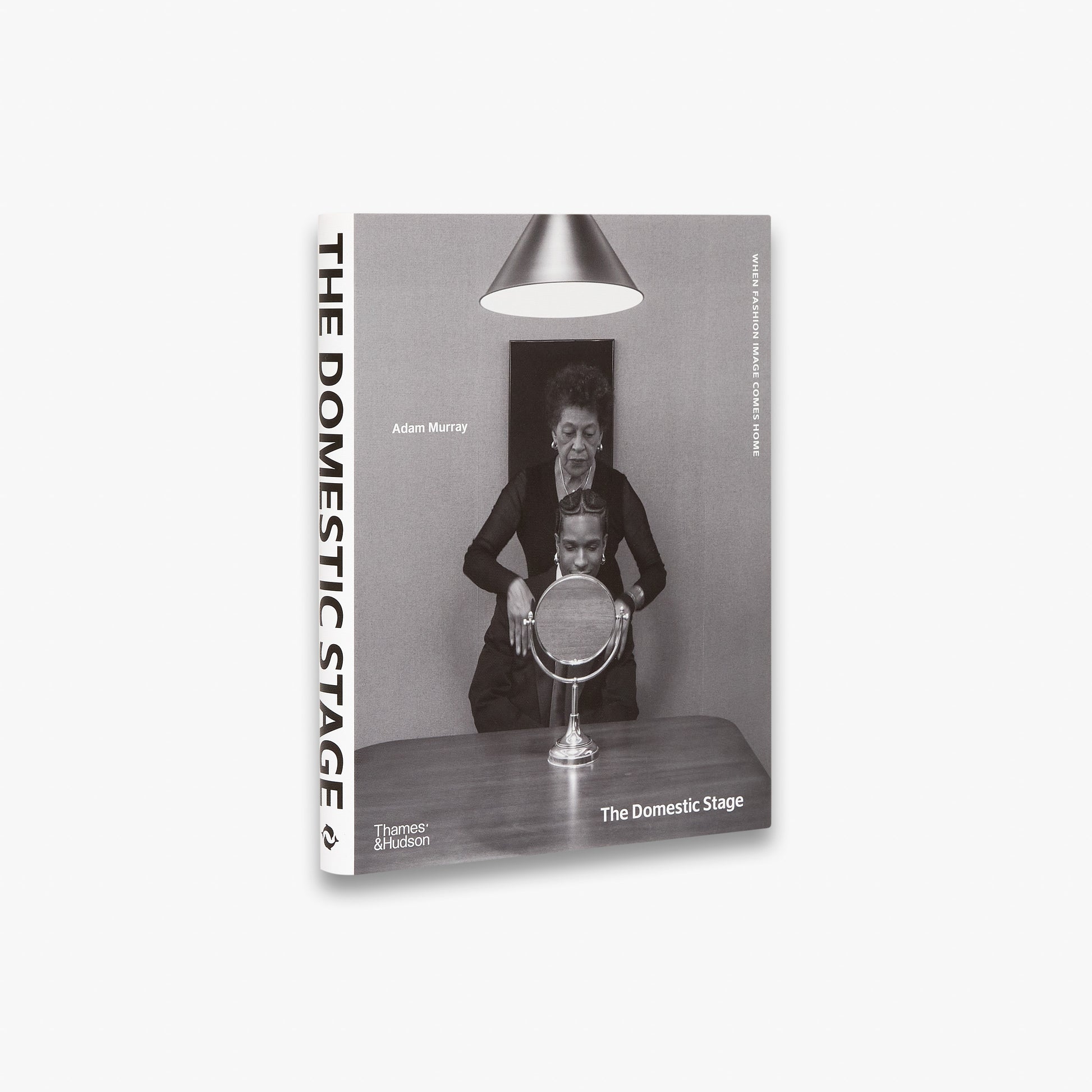 Book cover of 'The Domestic Stage' with a black and white photo of a woman and man with a mirror, on a white background.