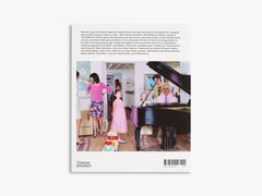 Back cover of a book with a photo of a family in a living room and a piano.