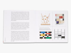 Book open to a page with text and geometric design illustrations on a white background