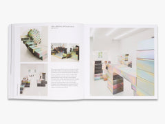 Open book showing interior design images of a modern living room.