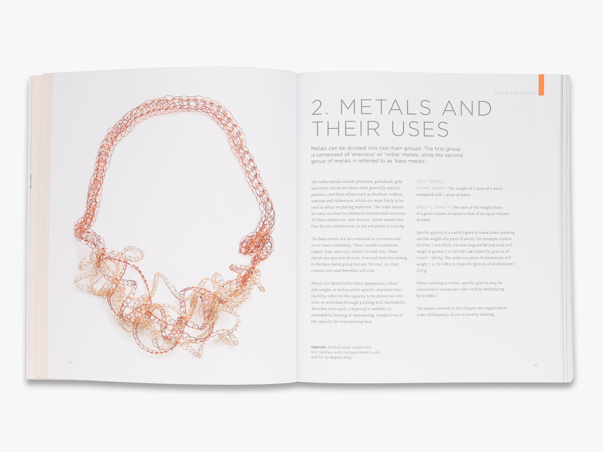 Open book showing a page about metals with an image of a copper necklace.