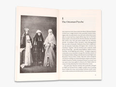 Open book with black and white photograph and text on a white background