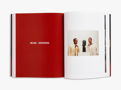 Open book with a red page and a photo of two people on a white background